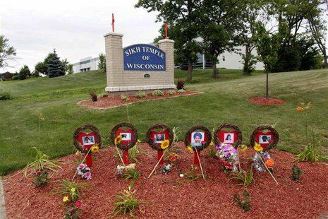 A memorial is set at the entrance to the Sikh Temple of Wisconsin, as mourners attend a candlelight vigil on the one-year anniversary of a m A memorial is set at the entrance to the Sikh Temple of Wisconsin, as mourners attend a candlelight vigil on the one-year anniversary of a m