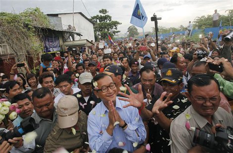 Sam Rainsy (C), president of the opposition Cambodia National Rescue Party (CNRP), greets supporters during a visit to the Boeung Kak lake a Sam Rainsy (C), president of the opposition Cambodia National Rescue Party (CNRP), greets supporters during a visit to the Boeung Kak lake a