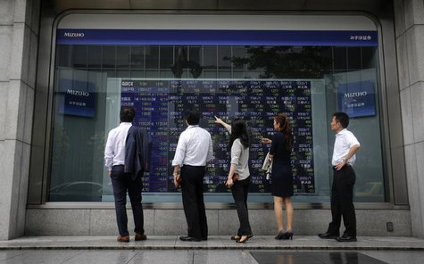 Pedestrians stand in front of a stock quotation board displaying various stock prices outside a brokerage in Tokyo July 29, 2013. REUTERS/Yu Pedestrians stand in front of a stock quotation board displaying various stock prices outside a brokerage in Tokyo July 29, 2013. REUTERS/Yu