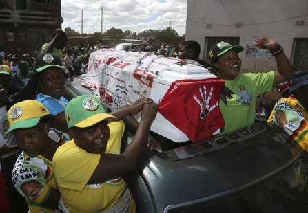 Supporters of ZANU-PF party celebrate with a coffin wrapped in a Movement for Democratic Change (MDC) flag in Mbare township, outside Harare Supporters of ZANU-PF party celebrate with a coffin wrapped in a Movement for Democratic Change (MDC) flag in Mbare township, outside Harare