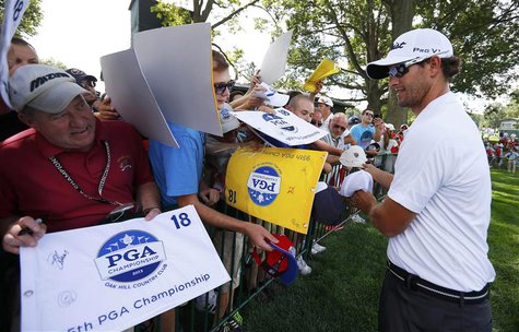 Australia's Adam Scott signs autographs during a practice round for the 2013 PGA Championship golf tournament at Oak Hill Country Club in Ro Australia's Adam Scott signs autographs during a practice round for the 2013 PGA Championship golf tournament at Oak Hill Country Club in Ro