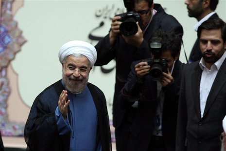 Iran's new President Hassan Rouhani (L) gestures as he arrives to his swearing-in ceremony at the Iranian Parliament in Tehran in this Augus Iran's new President Hassan Rouhani (L) gestures as he arrives to his swearing-in ceremony at the Iranian Parliament in Tehran in this Augus