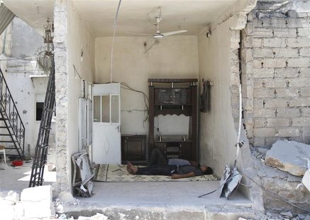 Men sleep inside a house damaged after what activists said was an air raid by forces loyal to Syria's President Bashar al-Assad in Azaz, nea Men sleep inside a house damaged after what activists said was an air raid by forces loyal to Syria's President Bashar al-Assad in Azaz, nea