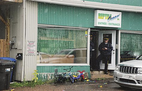 Police stand in front of the Reptile Ocean store in Campbellton, New Brunswick August 5, 2013 after an incident in which an African rock pyt Police stand in front of the Reptile Ocean store in Campbellton, New Brunswick August 5, 2013 after an incident in which an African rock pyt