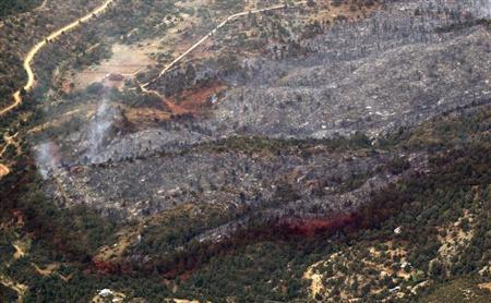 An aerial view of a strip of fire retardant near Yarnell, Arizona separating the burned area from the green area is seen on July 1, 2013.
Credit: Reuters/Rick Wilking An aerial view of a strip of fire retardant near Yarnell, Arizona separating the burned area from the green area is seen on July 1, 2013.
Credit: Reuters/Rick Wilking