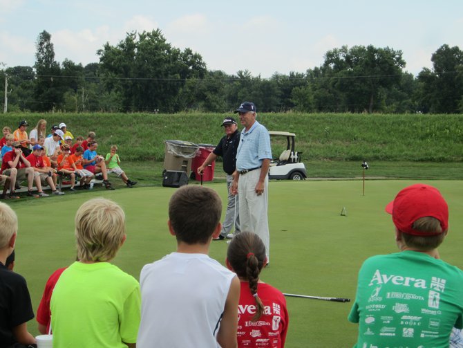 Peter Senior and Morris Hatalzky holding court at the Kids golf clinic. It's all about the short game.