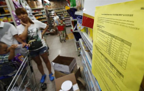 A woman looks at a notice about the product recall of some of Dumex and Abbott's milk powder products at a supermarket in Beijing August 7, A woman looks at a notice about the product recall of some of Dumex and Abbott's milk powder products at a supermarket in Beijing August 7,