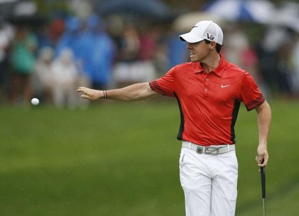 Northern Ireland's Rory McIlroy throws his ball in the water after scoring a double bogey on the 15th hole during the second round of the 20 Northern Ireland's Rory McIlroy throws his ball in the water after scoring a double bogey on the 15th hole during the second round of the 20