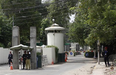 A policeman (2nd R) and private security personnel stand guard at the entrance of a road leading towards the U.S. consulate in Lahore August A policeman (2nd R) and private security personnel stand guard at the entrance of a road leading towards the U.S. consulate in Lahore August