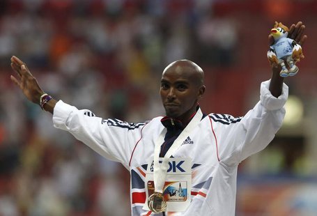 Gold medallist Mo Farah of Britian poses during the men's 10,000 metres victory ceremony at the IAAF World Athletics Championships at the Lu Gold medallist Mo Farah of Britian poses during the men's 10,000 metres victory ceremony at the IAAF World Athletics Championships at the Lu