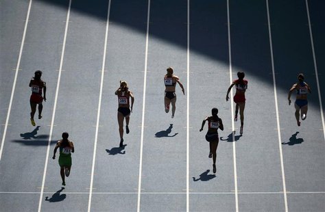 Competitors run in the women's 100 metres heats during the IAAF World Athletics Championships at the Luzhniki stadium in Moscow August 11, 2 Competitors run in the women's 100 metres heats during the IAAF World Athletics Championships at the Luzhniki stadium in Moscow August 11, 2