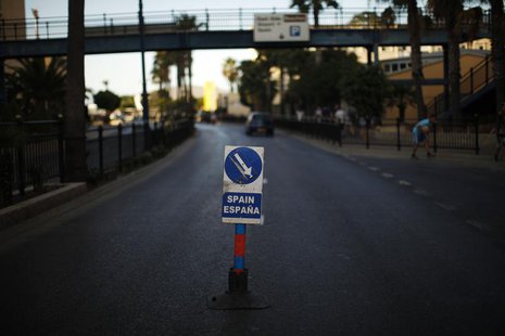 A traffic signal is seen in the middle of the Winston Churchill Avenue to indicate to the drivers the way to enter to Spain at its border wi A traffic signal is seen in the middle of the Winston Churchill Avenue to indicate to the drivers the way to enter to Spain at its border wi