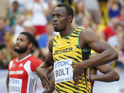 Usain Bolt of Jamaica (R) shows off his name as he is introduced before his men's 100 metres semi-finals during the IAAF World Athletics Cha Usain Bolt of Jamaica (R) shows off his name as he is introduced before his men's 100 metres semi-finals during the IAAF World Athletics Cha