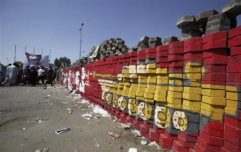 Members of the Muslim Brotherhood and supporters of ousted Egyptian President Mohamed Mursi guard bricks placed at the entrance to their cam Members of the Muslim Brotherhood and supporters of ousted Egyptian President Mohamed Mursi guard bricks placed at the entrance to their cam