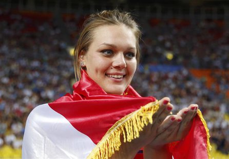 Sandra Perkovic of Croatia holds up her national flag as she celebrates winning the gold medal in the women's discus throw final during the Sandra Perkovic of Croatia holds up her national flag as she celebrates winning the gold medal in the women's discus throw final during the