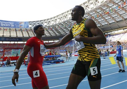 Usain Bolt of Jamaica (R) pushes Mike Rodgers of the U.S. in jest after winning his men's 100 metres semi-final during the IAAF World Athlet Usain Bolt of Jamaica (R) pushes Mike Rodgers of the U.S. in jest after winning his men's 100 metres semi-final during the IAAF World Athlet