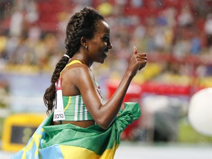 Tirunesh Dibaba of Ethiopia celebrates her victory in the women's 10,000 metres final during the IAAF World Athletics Championships at the L Tirunesh Dibaba of Ethiopia celebrates her victory in the women's 10,000 metres final during the IAAF World Athletics Championships at the L