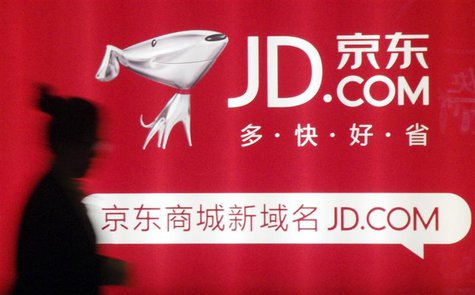 A woman walks past a advertisement board of Jingdong Mall in Nanjing, Jiangsu province May 7, 2013. REUTERS/China Daily A woman walks past a advertisement board of Jingdong Mall in Nanjing, Jiangsu province May 7, 2013. REUTERS/China Daily