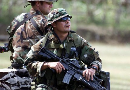 U.S. soldiers ride on an all terrain vehicle (ATV) after arriving at the 103rd Army Brigade headquarters near Isabela town on Basilan island U.S. soldiers ride on an all terrain vehicle (ATV) after arriving at the 103rd Army Brigade headquarters near Isabela town on Basilan island