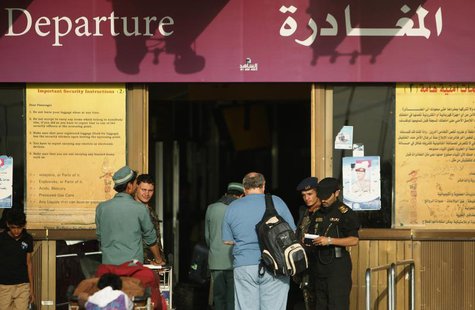 A police officer checks documents of a traveller outside the departure lounge Sanaa International Airport August 7, 2013. REUTERS/Khaled Abd A police officer checks documents of a traveller outside the departure lounge Sanaa International Airport August 7, 2013. REUTERS/Khaled Abd