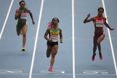 Shelly-Ann Fraser-Pryce of Jamaica (C) crosses the finish line between Gloria Asumnu of Nigeria (L) and Alexandria Anderson of the U.S. (R) Shelly-Ann Fraser-Pryce of Jamaica (C) crosses the finish line between Gloria Asumnu of Nigeria (L) and Alexandria Anderson of the U.S. (R)