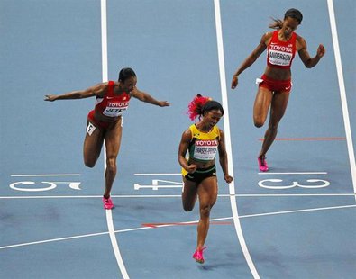 Shelly-Ann Fraser-Pryce of Jamaica (C) celebrates winning the women's 100 metres final next to Carmelita Jeter of the U.S. (L) and Alexandri Shelly-Ann Fraser-Pryce of Jamaica (C) celebrates winning the women's 100 metres final next to Carmelita Jeter of the U.S. (L) and Alexandri