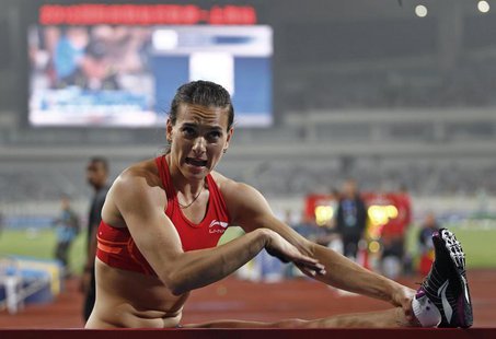 Russia's Yelena Isinbayeva talks to her coach (not pictured) during the women's pole vault at the IAAF Diamond League Athletics meet in Shan Russia's Yelena Isinbayeva talks to her coach (not pictured) during the women's pole vault at the IAAF Diamond League Athletics meet in Shan