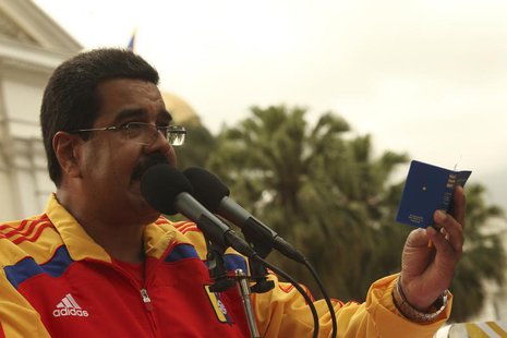Venezuela's President Nicolas Maduro (C) holds a copy of the Venezuelan constitution as he speaks during a rally in Caracas in this handout Venezuela's President Nicolas Maduro (C) holds a copy of the Venezuelan constitution as he speaks during a rally in Caracas in this handout
