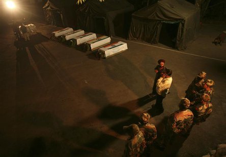 Indian army soldiers stand near the coffins of colleagues during a wreath laying ceremony in Poonch district, northwest of Jammu in this Aug Indian army soldiers stand near the coffins of colleagues during a wreath laying ceremony in Poonch district, northwest of Jammu in this Aug