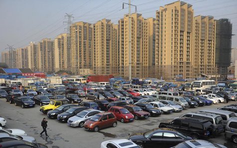 Car dealers and customers walk at a second-hand car market near a newly-built residential area in Hefei, Anhui province, January 26, 2013. R Car dealers and customers walk at a second-hand car market near a newly-built residential area in Hefei, Anhui province, January 26, 2013. R