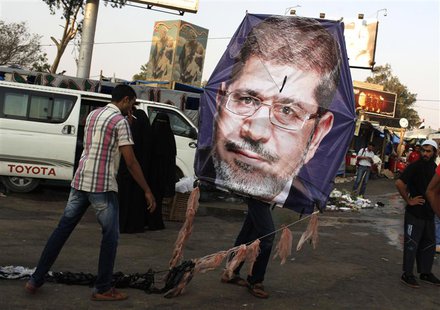 Supporters of deposed Egyptian President Mohamed Mursi fly a kite with a picture of Mursi, in the sit-in area of Rab'a al- Adawiya Square, w Supporters of deposed Egyptian President Mohamed Mursi fly a kite with a picture of Mursi, in the sit-in area of Rab'a al- Adawiya Square, w
