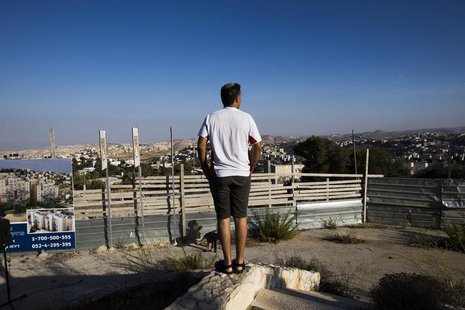 An Israeli man takes part in a ceremony announcing the resumption of construction of an Israeli neighbourhood in East Jerusalem August 11, 2 An Israeli man takes part in a ceremony announcing the resumption of construction of an Israeli neighbourhood in East Jerusalem August 11, 2