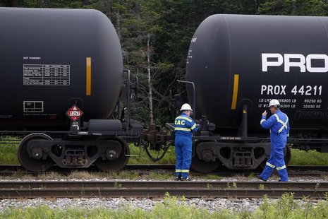 Inspectors for the transportation of dangerous goods (TDG) inspect a train on the track approximately 10km (6 miles) outside of the site of Inspectors for the transportation of dangerous goods (TDG) inspect a train on the track approximately 10km (6 miles) outside of the site of