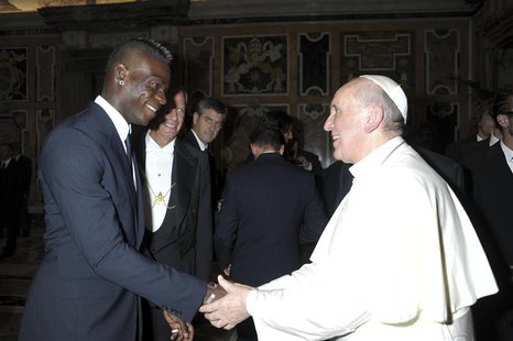 Italian national soccer player Mario Balotelli (L) shakes hands with Pope Francis during a private audience at the Vatican, August 13, 2013. Italian national soccer player Mario Balotelli (L) shakes hands with Pope Francis during a private audience at the Vatican, August 13, 2013.