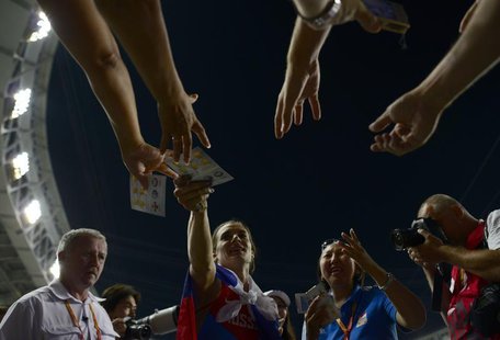Yelena Isinbayeva of Russia signs autographs after women's pole vault final at the IAAF World Athletics Championships at the Luzhniki stadiu Yelena Isinbayeva of Russia signs autographs after women's pole vault final at the IAAF World Athletics Championships at the Luzhniki stadiu