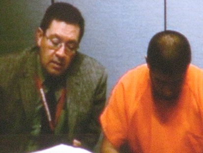 Jose Luis Flores Aca with his translator during bond hearing Jose Luis Flores Aca with his translator during bond hearing