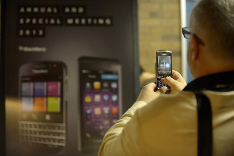 A Blackberry user takes a photograph of Blackberry signage at the company's annual meeting in Waterloo, Ontario July 9, 2013. REUTERS/Jon Bl A Blackberry user takes a photograph of Blackberry signage at the company's annual meeting in Waterloo, Ontario July 9, 2013. REUTERS/Jon Bl