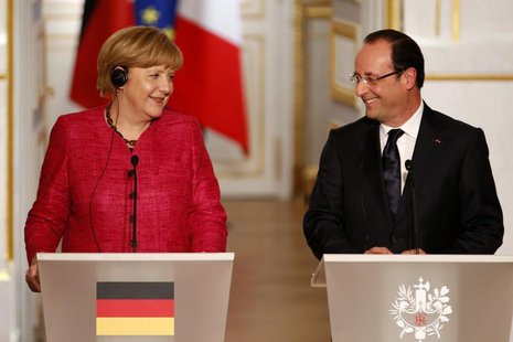 France's President Francois Hollande (R) and German Chancellor Angela Merkel attend a joint news conference at the Elysee Palace in Paris, M France's President Francois Hollande (R) and German Chancellor Angela Merkel attend a joint news conference at the Elysee Palace in Paris, M