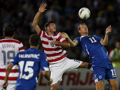 Bosnia's Edin Dzeko (R) fights for the ball against Brad Evans of the U.S. during their international friendly soccer match in Sarajevo, Aug Bosnia's Edin Dzeko (R) fights for the ball against Brad Evans of the U.S. during their international friendly soccer match in Sarajevo, Aug