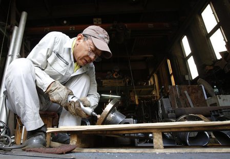 A man works inside a factory in Tokyo August 12, 2013. REUTERS/Yuya Shino A man works inside a factory in Tokyo August 12, 2013. REUTERS/Yuya Shino