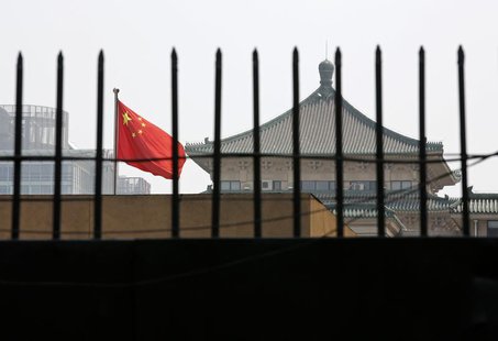 The national flag of China flutters behind a fence of the headquarters of the National Development and Reform Commission (NDRC) in Beijing, The national flag of China flutters behind a fence of the headquarters of the National Development and Reform Commission (NDRC) in Beijing,