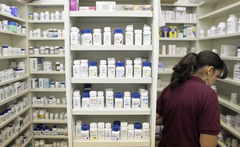 A pharmacy employee looks for medication as she works to fill a prescription while working at a pharmacy in New York December 23, 2009. REUT A pharmacy employee looks for medication as she works to fill a prescription while working at a pharmacy in New York December 23, 2009. REUT