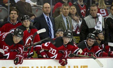 New Jersey Devils head coach Peter DeBoer (back 2nd L) and assistant coach Dave Barr (back 3rd L) stand on the bench with their players as t New Jersey Devils head coach Peter DeBoer (back 2nd L) and assistant coach Dave Barr (back 3rd L) stand on the bench with their players as t