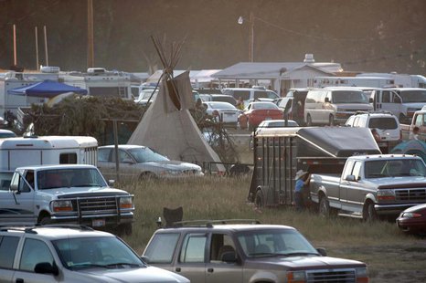 A traditional tipi is surrounded by cars as the parking lot fills up for the Oglala Nation Pow Wow and Rodeo in Pine Ridge, South Dakota, Au A traditional tipi is surrounded by cars as the parking lot fills up for the Oglala Nation Pow Wow and Rodeo in Pine Ridge, South Dakota, Au