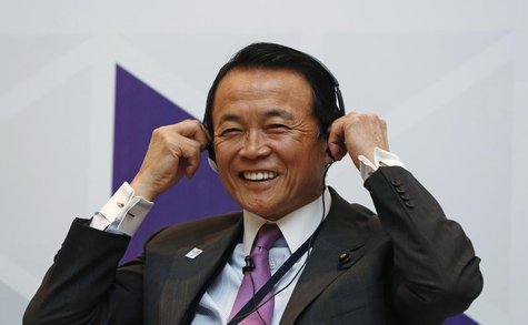 Japan's Finance Minister Taro Aso smiles as he adjusts his headphones during a seminar at the Asian Development Bank's (ADB) 46th annual boa Japan's Finance Minister Taro Aso smiles as he adjusts his headphones during a seminar at the Asian Development Bank's (ADB) 46th annual boa
