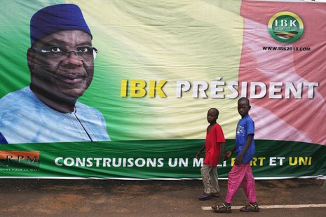Boys walk in front of a poster of Mali's President-elect Ibrahim Boubacar Keita in Bamako August 13, 2013. REUTERS/Joe Penney Boys walk in front of a poster of Mali's President-elect Ibrahim Boubacar Keita in Bamako August 13, 2013. REUTERS/Joe Penney