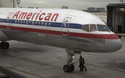 A worker walks underneath an American Airlines airplane at Miami International airport in Miami, Florida November 29, 2011. REUTERS/Lucas Ja A worker walks underneath an American Airlines airplane at Miami International airport in Miami, Florida November 29, 2011. REUTERS/Lucas Ja