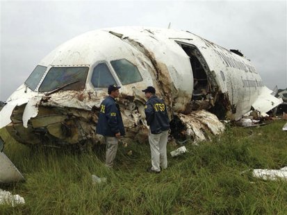 Inspectors survey the wreckage of a UPS Airbus A300 cargo plane which crashed near the airport in Birmingham, Alabama August 14, 2013 in thi Inspectors survey the wreckage of a UPS Airbus A300 cargo plane which crashed near the airport in Birmingham, Alabama August 14, 2013 in thi