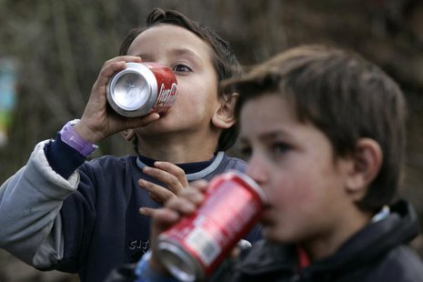 Children of the Kosovo Ashkalli minority drink during a ribbon-cutting ceremony for their new home in the village of Magure in central Kosov Children of the Kosovo Ashkalli minority drink during a ribbon-cutting ceremony for their new home in the village of Magure in central Kosov