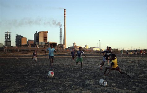 Boys play soccer in Marikana's Nkaneng township in front of the Lonmin's Marikana platinum mine in Rustenburg, 100 km (62 miles) northwest o Boys play soccer in Marikana's Nkaneng township in front of the Lonmin's Marikana platinum mine in Rustenburg, 100 km (62 miles) northwest o